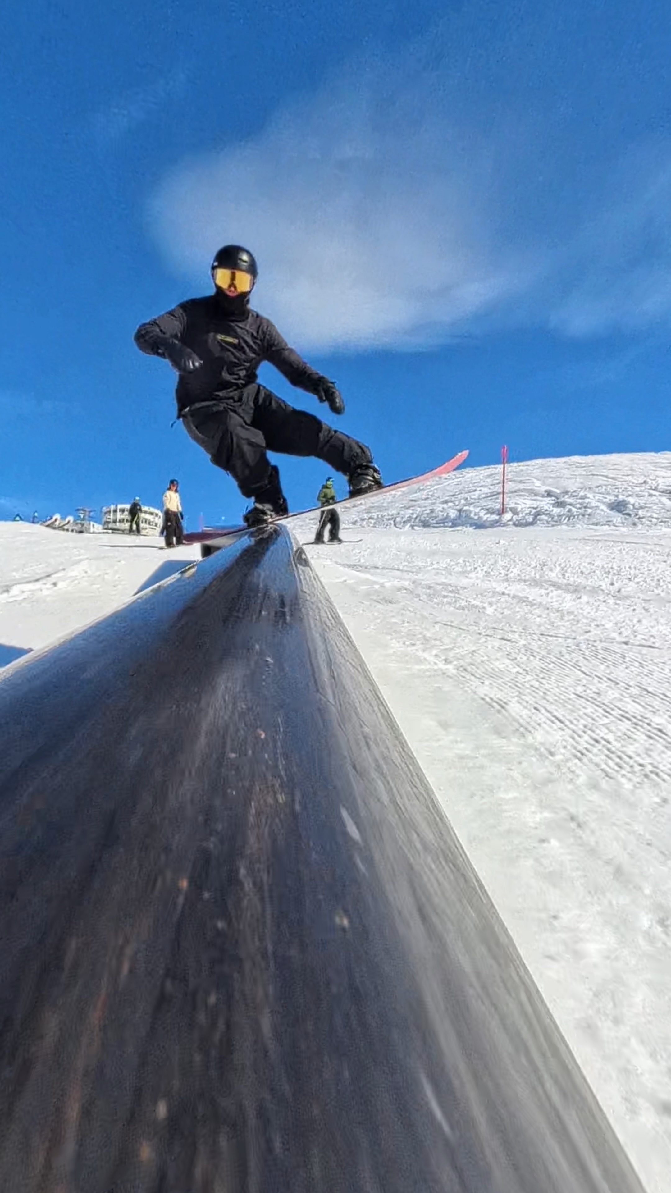 Jonas Hasler performing an inverted snowboard trick in the halfpipe