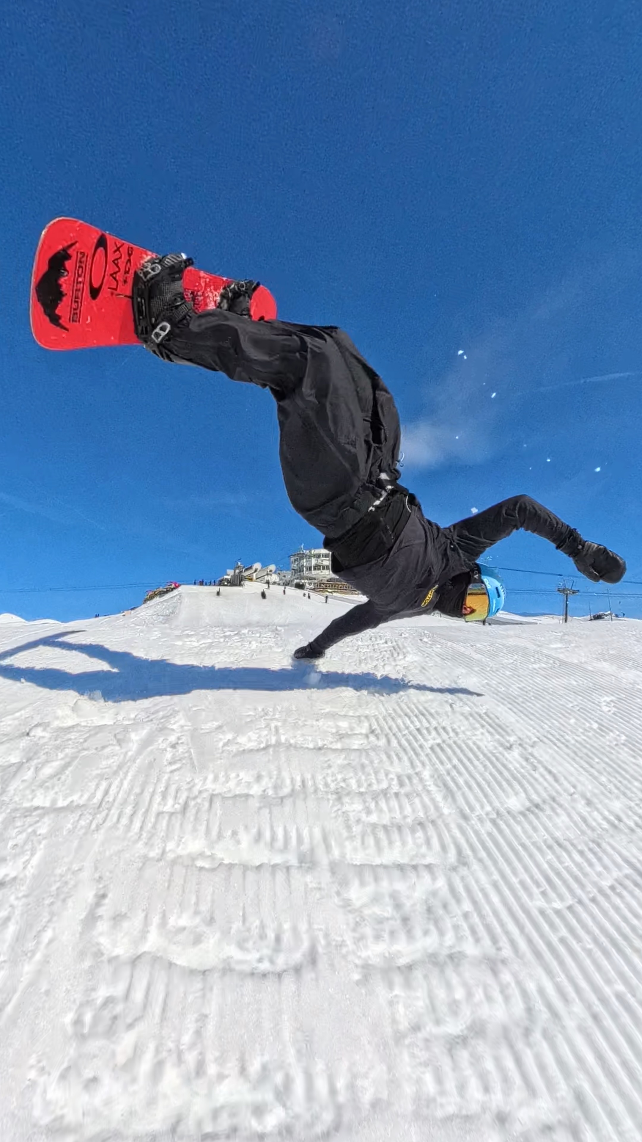 Jonas Hasler holding a snowboard grab during a halfpipe run