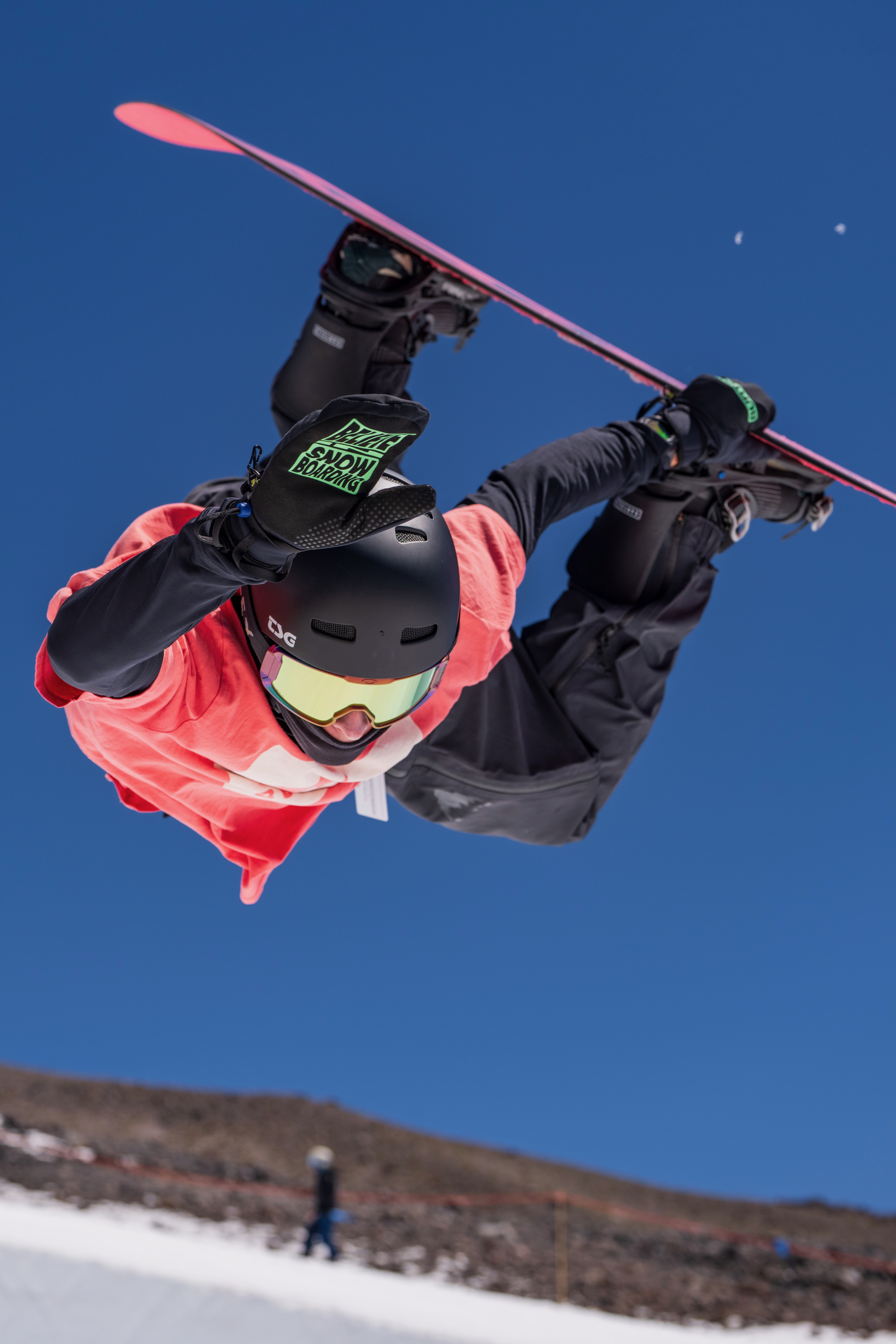 Jonas Hasler captured in a snowboard action sequence above spectators